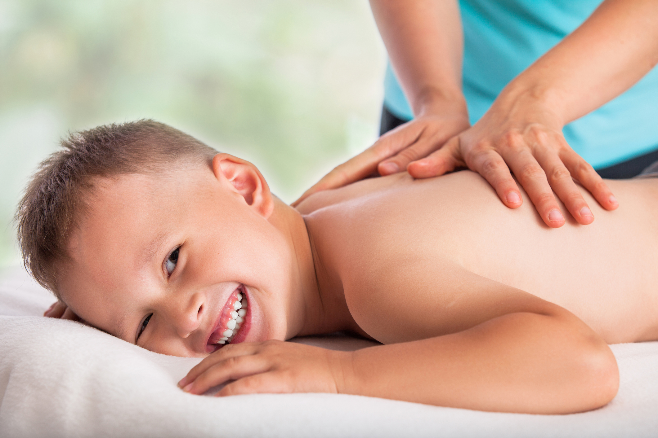 Masseur doing massage boy, massage boy love, he is happy and relaxed Masseur doing massage boy, massage boy love, he is happy and relaxed