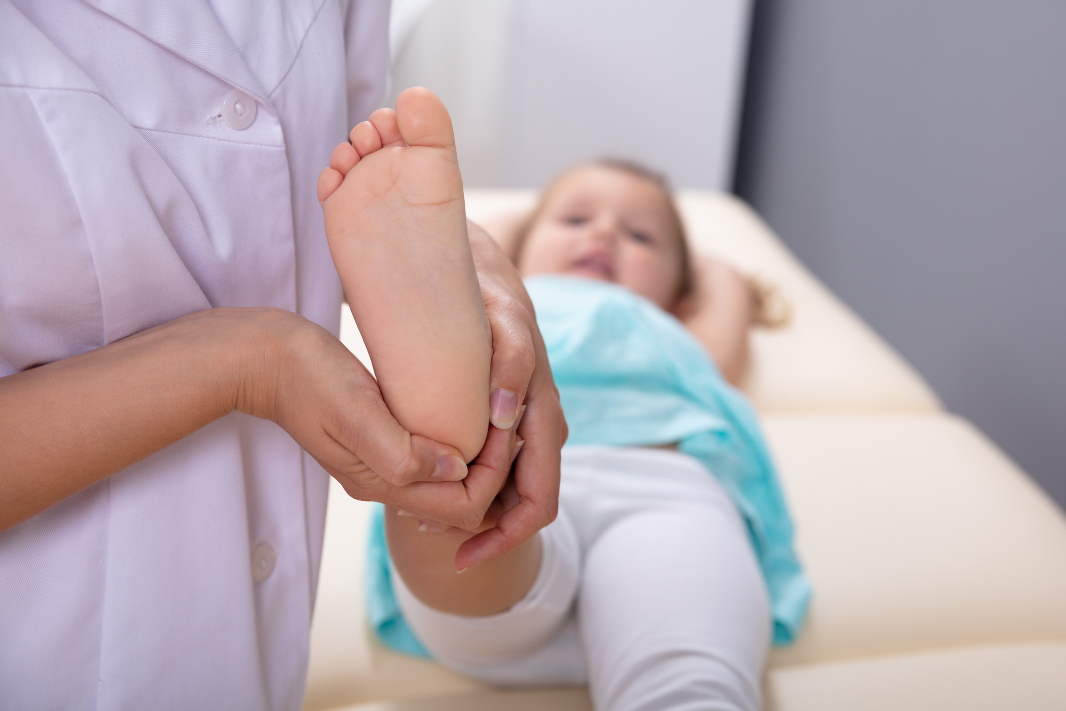 Physiotherapist Working With Patient In Clinic Close-up Of Female Physiotherapist Doing Girl's Foot Massage In Medical Clinic