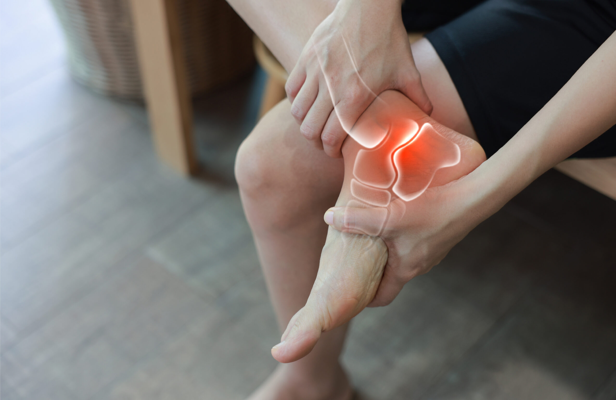Woman standing and massaging her painful ankle with anatomical bone and joint illustration. Ankle sprain, arthritis, Achilles tendonitis and ligament injury concept for medical health care.